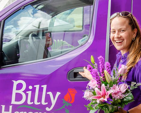 One of our drivers heads out in a purple van to deliver a gorgeous purple and pink bouquet